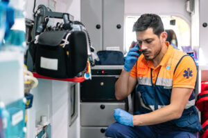 First responder in an ambulance taking an emergency call